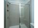 Modern tiled shower with sleek glass doors and a built-in shower shelf for storage at 1402 Twin Rivers Dr, Wando, SC 29492
