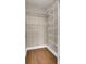 A spacious closet with wood-look flooring and white adjustable shelving system at 1505 Basildon Rd, Mount Pleasant, SC 29466