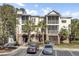 Three-story building featuring screened porches, palm trees, and front parking at 1505 Basildon Rd, Mount Pleasant, SC 29466