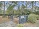 Gated entry into the community garden with Plantin Thyme signage and wooden bench seating at 1505 Basildon Rd, Mount Pleasant, SC 29466