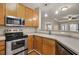 A clean kitchen features stainless steel oven and microwave, granite countertop, and pendant lighting at 1505 Basildon Rd, Mount Pleasant, SC 29466