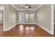 Bright living room featuring hardwood floors, ceiling fan, and a door to the outside at 1505 Basildon Rd, Mount Pleasant, SC 29466