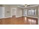 A neutral living room featuring hardwood floors, ceiling fan and an entry door to the outside patio at 1505 Basildon Rd, Mount Pleasant, SC 29466