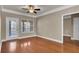 This living room is bright with hardwood floors, ceiling fan, and trim at 1505 Basildon Rd, Mount Pleasant, SC 29466