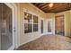 Enclosed porch with rustic ceiling and multiple exterior access doors at 1505 Basildon Rd, Mount Pleasant, SC 29466