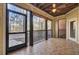 Enclosed porch with rustic ceiling fan and views of the surrounding woods at 1505 Basildon Rd, Mount Pleasant, SC 29466