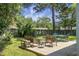 A backyard featuring a wooden deck with multiple seating areas, grass, and many trees at 1520 Wakendaw Rd, Mount Pleasant, SC 29464