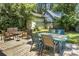 A backyard featuring a wooden deck with multiple seating areas and lush greenery at 1520 Wakendaw Rd, Mount Pleasant, SC 29464
