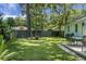 Lush backyard featuring a well-maintained lawn, mature trees, and a cozy outdoor dining area for entertaining at 1520 Wakendaw Rd, Mount Pleasant, SC 29464