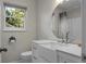 Bathroom featuring a bright window, a bright vanity, toilet, and a shower with a rain shower head at 1520 Wakendaw Rd, Mount Pleasant, SC 29464