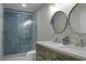 Bright bathroom featuring a double sink vanity with modern faucets and a glass shower at 1520 Wakendaw Rd, Mount Pleasant, SC 29464