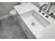Close-up of a bathroom vanity with a rectangular sink, modern faucet, and decorative patterned floors at 1520 Wakendaw Rd, Mount Pleasant, SC 29464