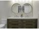 Bright bathroom featuring a double sink vanity with modern faucets and a double vanity mirror at 1520 Wakendaw Rd, Mount Pleasant, SC 29464