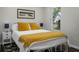 Cozy bedroom with bright natural light, a white frame bed, and decorative yellow pillows at 1520 Wakendaw Rd, Mount Pleasant, SC 29464