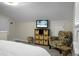 Cozy bedroom with plush seating area with patterned chair at 1520 Wakendaw Rd, Mount Pleasant, SC 29464