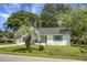 Charming single-story home features a brick facade, dark roof, palm trees, and well-maintained lawn at 1520 Wakendaw Rd, Mount Pleasant, SC 29464