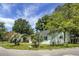 Charming single-story home features a brick facade, dark roof, palm trees, and well-maintained lawn at 1520 Wakendaw Rd, Mount Pleasant, SC 29464