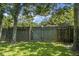 Backyard features a sturdy wooden fence, lush green lawn, and mature trees for added privacy and shade at 1520 Wakendaw Rd, Mount Pleasant, SC 29464