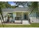 Cozy front porch featuring white brick, seating, and an inviting entrance at 1520 Wakendaw Rd, Mount Pleasant, SC 29464