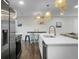 Kitchen boasts modern design with stainless appliances, large island, and unique decorative lighting at 1520 Wakendaw Rd, Mount Pleasant, SC 29464