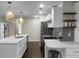 Clean kitchen with stainless appliances, white cabinetry, subway tile backsplash and unique decorative lighting at 1520 Wakendaw Rd, Mount Pleasant, SC 29464