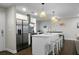 Bright kitchen features stainless appliances, island with bar seating, and unique pendant lighting at 1520 Wakendaw Rd, Mount Pleasant, SC 29464