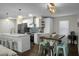 Open concept kitchen with stainless appliances, bar-top seating, and adjacent dining area at 1520 Wakendaw Rd, Mount Pleasant, SC 29464