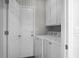 A laundry room with washer, dryer and cabinets for ample storage space at 1520 Wakendaw Rd, Mount Pleasant, SC 29464