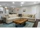 Open-concept living room includes a large sectional, wood coffee table, and decorative lighting at 1520 Wakendaw Rd, Mount Pleasant, SC 29464