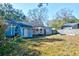 Fenced backyard with shade trees and a charming rear home elevation at 1556 Larry St, North Charleston, SC 29405