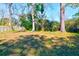 Expansive backyard with mature trees offering shade, perfect for outdoor activities at 1556 Larry St, North Charleston, SC 29405