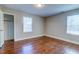 Bright bedroom featuring hardwood floors, neutral walls, and a closet for ample storage at 1556 Larry St, North Charleston, SC 29405