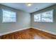 Cozy bedroom with hardwood floors and two windows providing natural light at 1556 Larry St, North Charleston, SC 29405