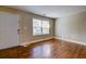 Cozy living area with hardwood flooring, door, and large window at 1556 Larry St, North Charleston, SC 29405