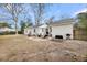 Backyard with a fire pit, outdoor seating area, and a well-maintained lawn, bordered by a fence at 17 Anita Dr, Charleston, SC 29407
