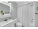 White bathroom with a single sink vanity, toilet, and shower/tub combo with white curtain at 17 Anita Dr, Charleston, SC 29407