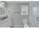 Bathroom with walk-in shower, marble countertop vanity, and a bright window at 17 Anita Dr, Charleston, SC 29407
