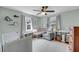Well-lit Bedroom with neutral walls, wood-look floors, a crib, changing table, and glider chair at 17 Anita Dr, Charleston, SC 29407