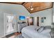 Bedroom featuring wood ceiling, neutral walls, and access to a balcony and en-suite bathroom at 17 Anita Dr, Charleston, SC 29407