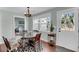 Cozy dining area with a round wooden table, patterned rug, and natural light at 17 Anita Dr, Charleston, SC 29407