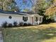 Quaint one-story house with a red door and a well maintained front lawn at 17 Anita Dr, Charleston, SC 29407