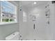 Modern tiled shower featuring glass doors and built-in shelving at 17 Anita Dr, Charleston, SC 29407