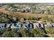 An aerial view of the property surrounded by mature trees, with a pedestrian bridge to the left of the home at 184 Scott St, Daniel Island, SC 29492