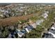 Wide aerial of the neighborhood and home showcasing a pool and backyard surrounded by verdant landscaping at 184 Scott St, Daniel Island, SC 29492