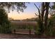 Scenic marsh view with mature trees at sunset from backyard bench at 184 Scott St, Daniel Island, SC 29492