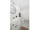 Bright bathroom featuring a vanity with sleek hardware, modern lighting, round mirror, and shower curtain, offering a clean design at 184 Scott St, Daniel Island, SC 29492