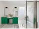 Bright bathroom featuring dual sinks, a soaking tub, and a separate shower with green accents at 184 Scott St, Daniel Island, SC 29492