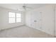 Bright bedroom with neutral carpet, ceiling fan, double closet doors, and natural light from a window at 184 Scott St, Daniel Island, SC 29492