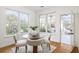 Bright dining nook with a wood table, surrounded by windows, offers an inviting place to eat at 184 Scott St, Daniel Island, SC 29492
