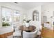 Cozy dining area with a round table, chairs, and bright light from windows overlooking the exterior at 184 Scott St, Daniel Island, SC 29492